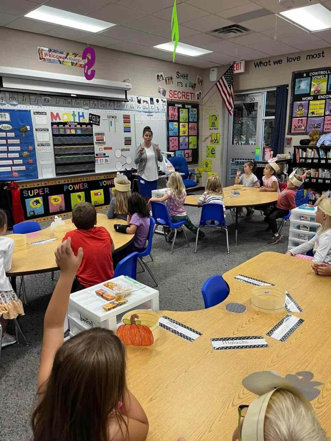 kindergarten teacher in front of class giving instruction